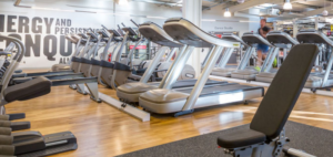 a row of empty treadmills in a gym