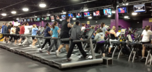 the cardio room of a busy gym