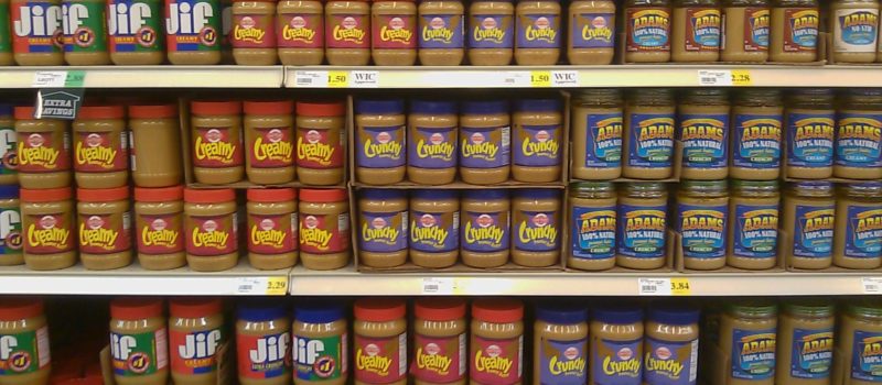 jars of peanut butter on grocery store shelves
