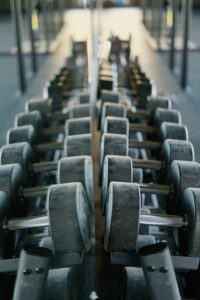Rack of dumbbells reflected in mirror in Catalyst 4 Fitness gym